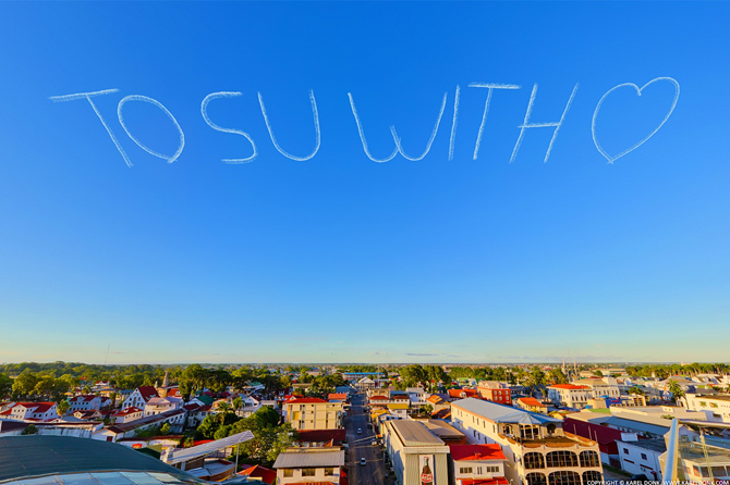 Skywriting above Paramaribo as seen from the Penthouse of the Wyndham Garden Hotel